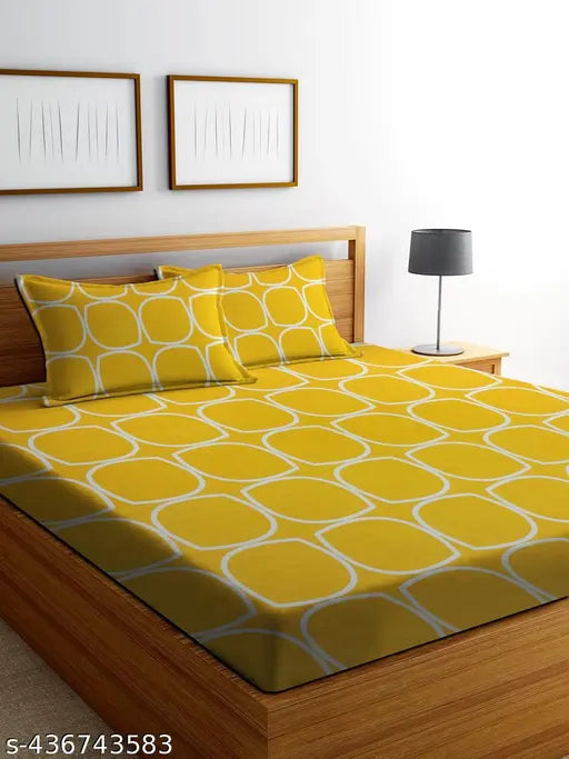Comfortable yellow glace cotton double bedsheet set with two matching pillow covers, ideal for summer and adult use