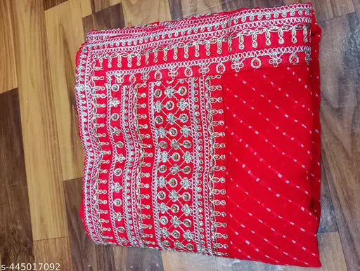 Trendy, vibrant red saree with intricate patterns and designs