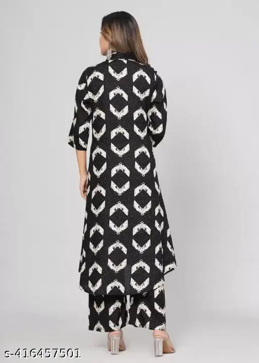 Black rayon kurta set with printed net pattern, three-quarter sleeves, paired with rayon pants. Elegant black design kurti for modern women, featuring intricate embroidery and embellishments. Versatile wardrobe essential in premium breathable fabric