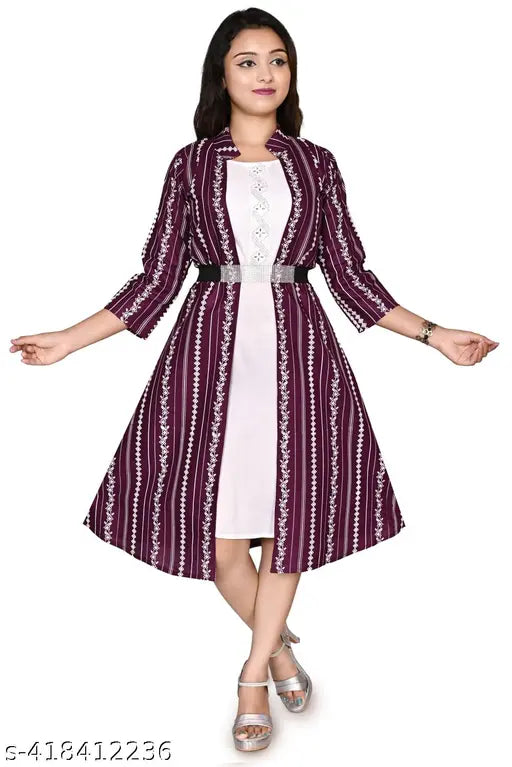 A girl in a purple and white patterned dress, with a black belt at the waist