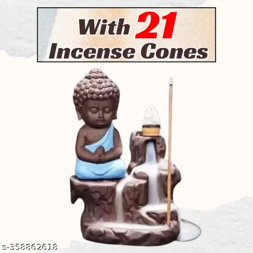 Blue Buddha idol sitting on faux marble with cones and a candle, 21 cones
