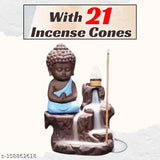 Blue Buddha idol sitting on faux marble with cones and a candle, 21 cones