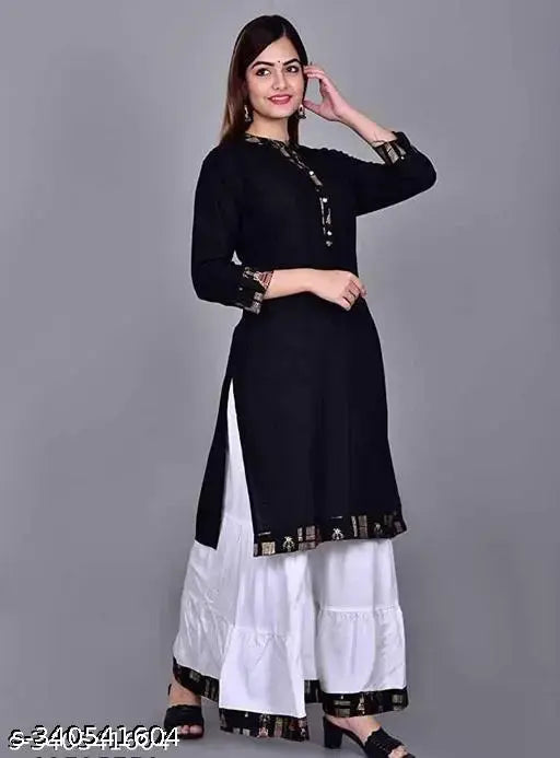 Attractive woman in black and white salwar kameez set with traditional embroidery