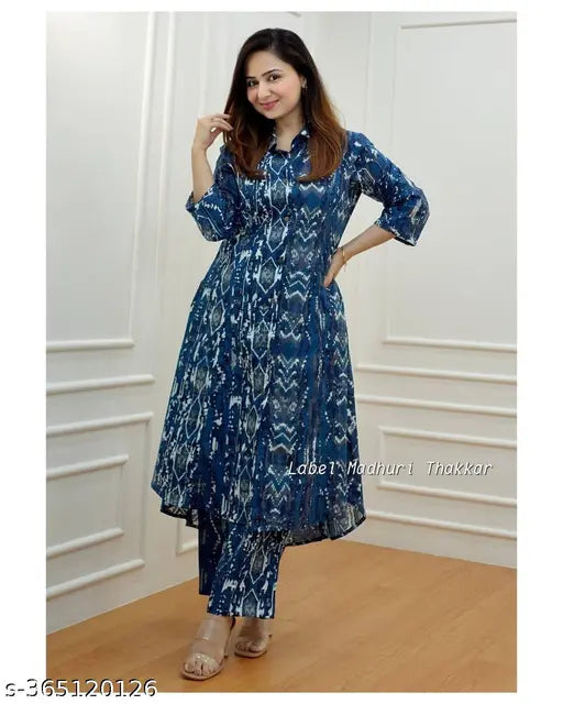 Blue cotton Anarkali gown with floral print and three-quarter sleeves, ideal for casual wear. Indian women's fashion set includes pants
