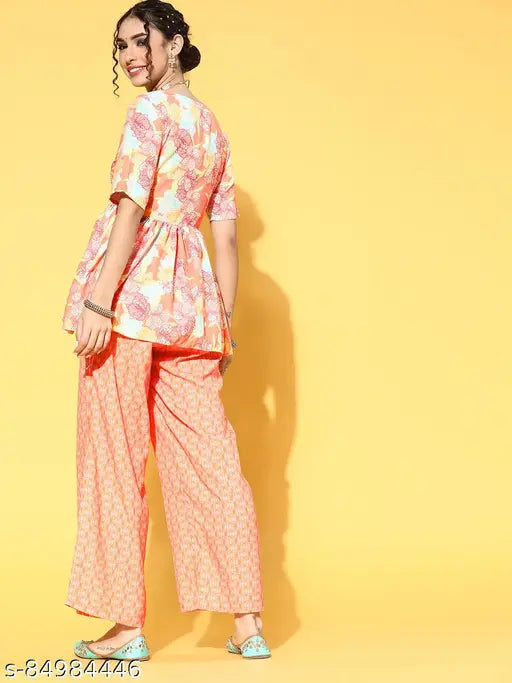 Multi-colored cotton digital print flared kurta with palazzo set, featuring a plunging neckline, short sleeves, and front slit. Floral peplum top and geometrically patterned palazzo pants from India