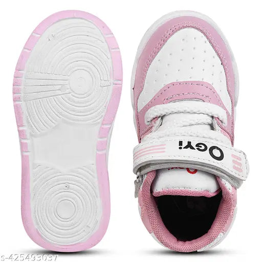 Pink and white sports shoes for kids, featuring a Velcro strap and flat sole