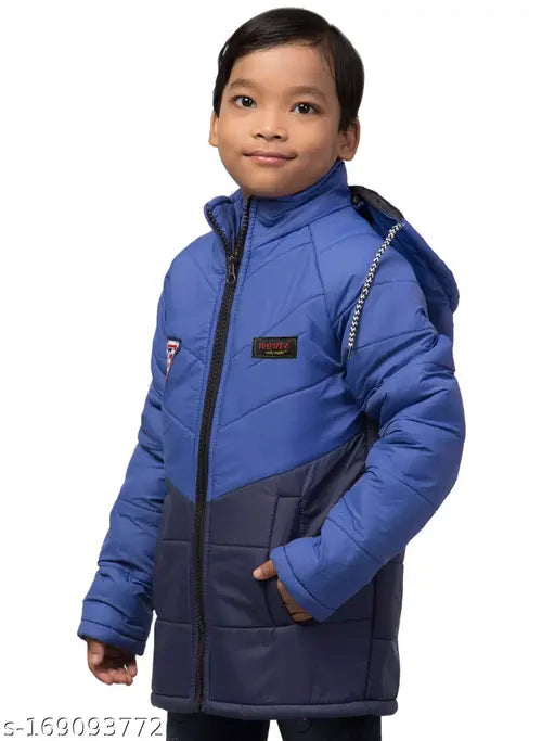 The image depicts a young boy standing against a plain background, wearing a bright blue coat with a hood. The coat has a zipper front closure and a distinctive emblem on the left chest area. The style of the jacket is trendy and modern