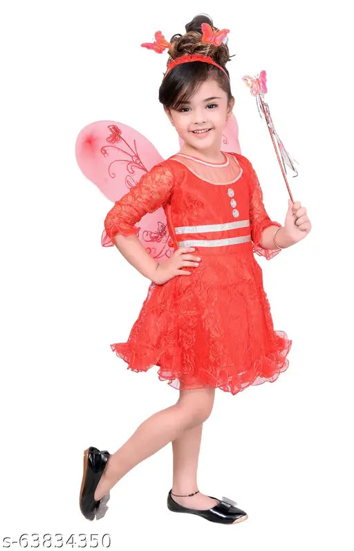 Little girl in red pari dress with wings, holding wand