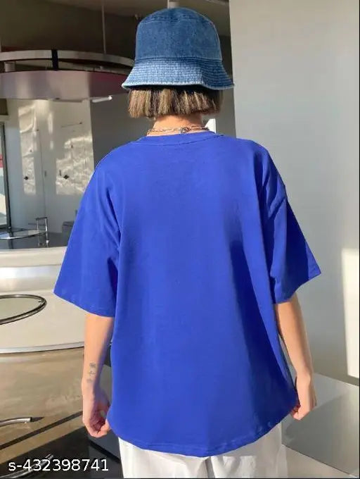 The image shows a person standing and wearing a blue baggy t-shirt