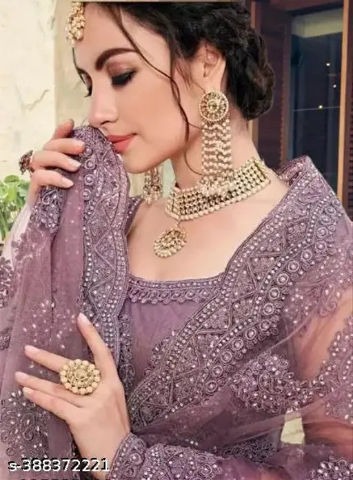Embroidered Kalidar lehenga choli set, free size net topwear and bottomwear with embellished dupatta, Indian bridal attire on display