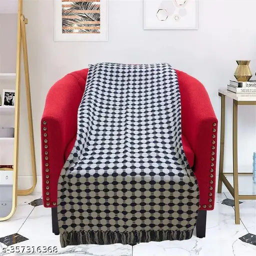 Red and gray plaid throw blanket on a chair
