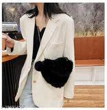Black faux fur crossbody bag with large heart charm