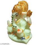 Green and gold ceramic statue of Ganesha, four-inch figure with a radium interior, seated pose, intricate detailing