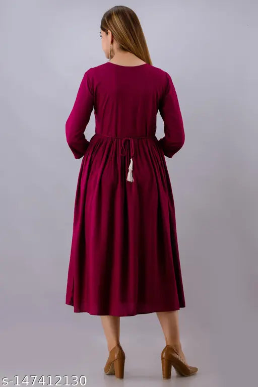 The image depicts a long, sleeveless dress with embroidery, possibly viscose or rayon material, in a darker shade such as burgundy or maroon. It appears to be a women's garment with a V-neckline and an A-line silhouette. The bottom hem is not fully visible, but it seems to fall straight down from the waist