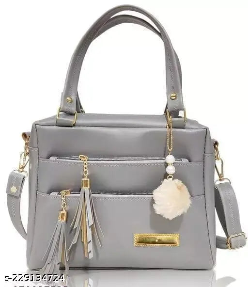 Silver purse with tassel, leather handle, and flap closure