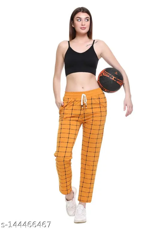 Women's track pants in bright orange checkered pattern with drawstring closure