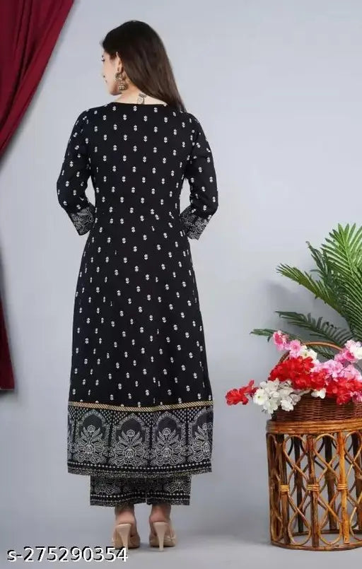 Women's rayon printed Anarkali Kurta set with palazzos and dupatta, features three-quarter sleeves and a vibrant print design. Rayon fabric. Indian handcrafted ethnic wear on display
