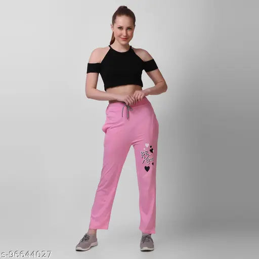 Pink sweatpants with a black top, heart graphic detailing brand or model