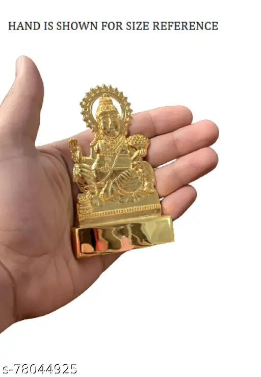 This is a small statue or idol of Lord Kubera, depicted in a seated pose and dressed in traditional attire, set against a plain background. It appears to be made of brass with gold accents, standing 11 cm tall. The figure has a serene expression on its face and holds a staff in its hand. This decorative showpiece is often used in home or temple interiors as a symbol of prosperity and wealth