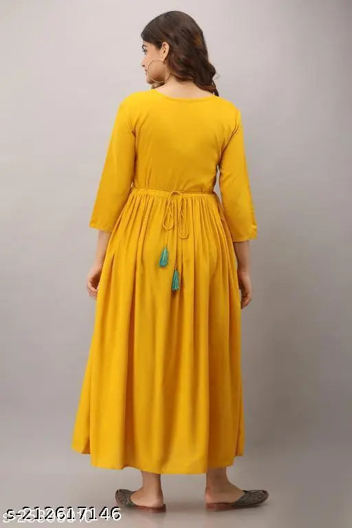Mustard yellow embroidered anarkali dress with long sleeves and high waist, shown on woman