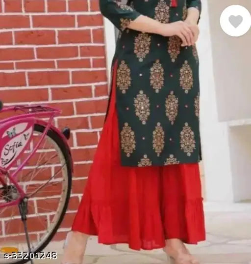 This is an image of a woman wearing an elegant long kurta with intricate patterns and a matching churidhar. The outfit appears to be suitable for formal occasions or cultural events, and the color scheme suggests a festive or traditional attire