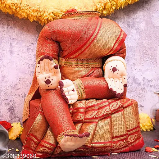 Red and gold traditional saree fabric adorned with a seated varalakshmi idol, embellished with flowers