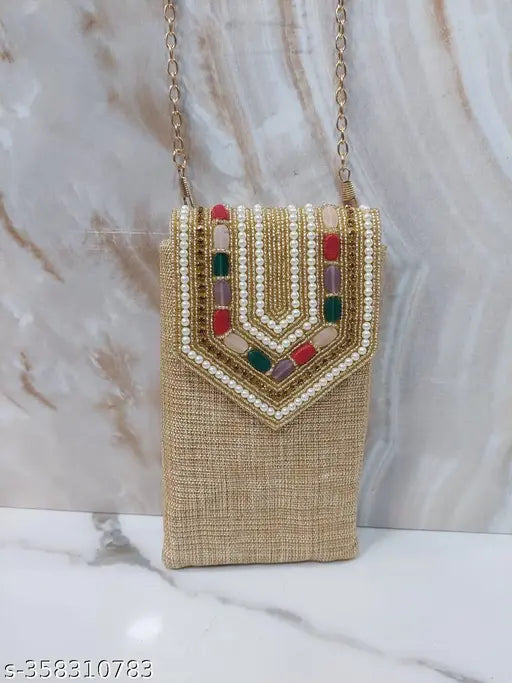 Brown woven clutch with sling design, featuring a large rectangular opening and hook for hanging. The clutch is detailed with sequins and embroidery, giving it an intricate appearance. A chain strap is attached to the top right corner of the clutch for hands-free carrying. The purse is displayed against a marble background, showcasing its design and texture