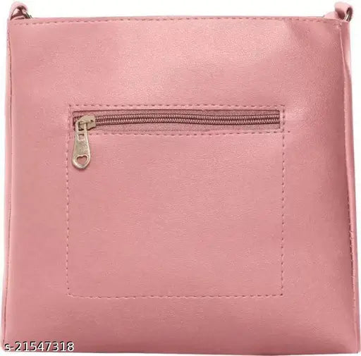 Pink leather sling bag with two straps and a zip closure