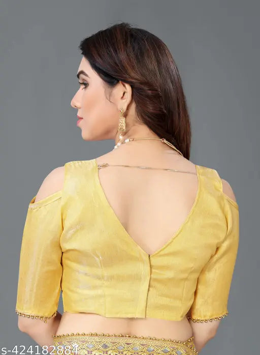 Yellow georgette saree with open back design, worn by a person at a festive occasion