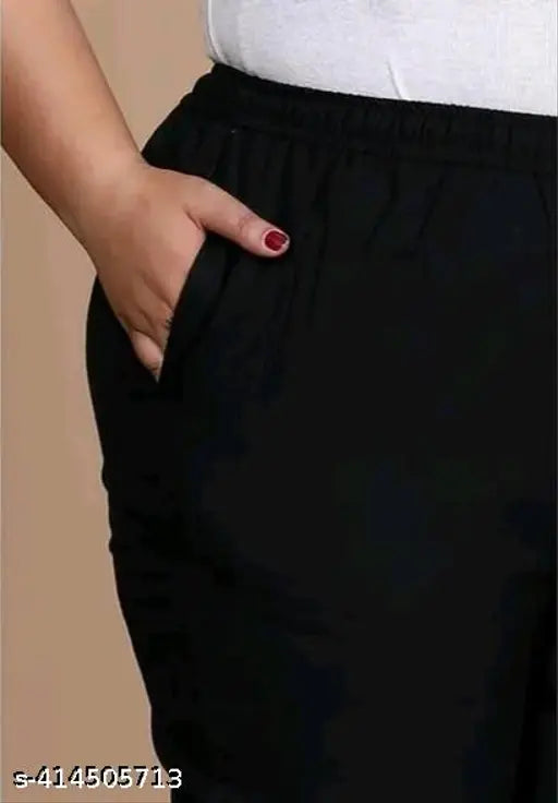 Black cotton blend plus size trousers with side pockets, mid rise, wide elastic waistband, and slit at bottom | Ladies plus size pants for comfortable style