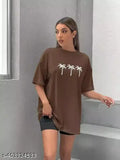 Woman in brown oversized t-shirt with palm trees graphic