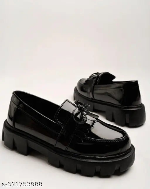 Black patent leather loafers for girls, detailed with chain accents - casual footwear accessory in solid net display