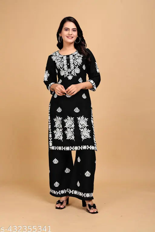 Black rayon kurta set with embroidered net pants, three-quarter sleeves. Rayon bottomwear and sleeves. Size M (bust 36in, waist 34in, length 39in), L (bust 38in, waist 32in), XL (bust 40in, waist 34in), XXL (bust 42in, waist 36in), XXXL (bust 44in, waist 38in), 4XL (bust 46in, waist 40in). Made in India