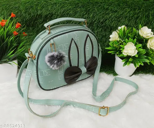 A light green sling bag with two fluffy furry attachments