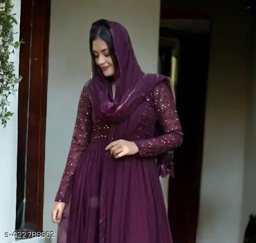 Elegant georgette gown, embroidered in floral patterns, paired with dupatta. Indian bridal wear on mannequin