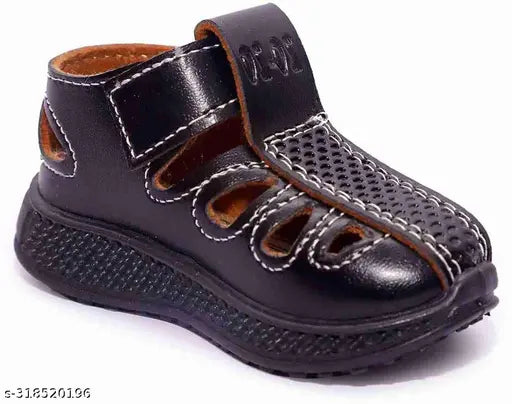 Brown synthetic leather kids' shoe-sandals for ages 3 months to 7 years, suitable for regular and party wear. Adjustable velcro straps, breathable upper material, and flexible sole. Comfortable playtime footwear for children