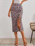 A woman wearing a maroon, black-printed bodycon skirt with high-heeled sandals against a white wall