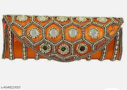 Orange embellished clutch with mirror detailing and decorative trim