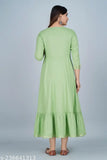 A woman wearing a light green anarkali kurta with embroidery details, possibly satin fabric, long sleeves, and a traditional ruffled hem