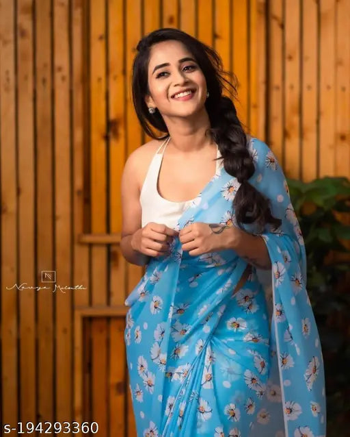 Blue and white floral sari worn by a woman