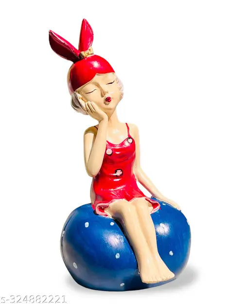 Cute red girl figurine sitting on stone statue, modern home decor