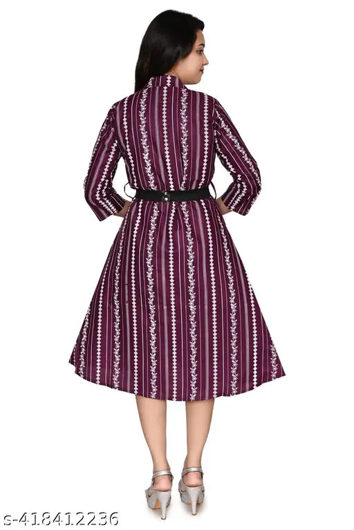 Purple patterned midi dress with a fitted waist, long sleeves