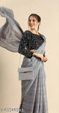 Fashionable light grey chiffon saree with long flowy border, sleeveless blouse, embellished waist, and shoulder strap