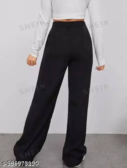 Girl wearing black trousers with a cropped top
