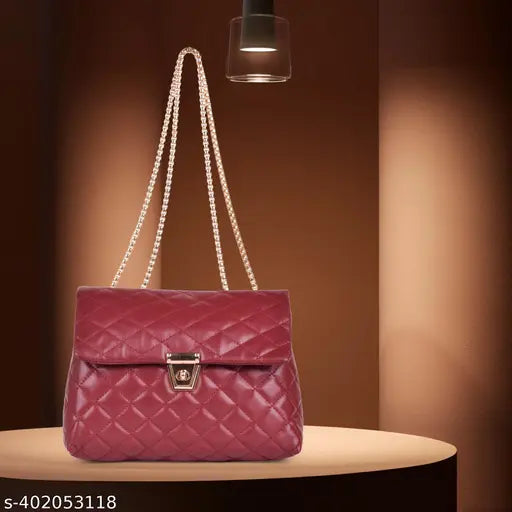 Red shoulder bag with crossbody sling strap, featuring quilted pattern and metallic zip closure