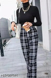 A pair of black and white women's checkered trousers