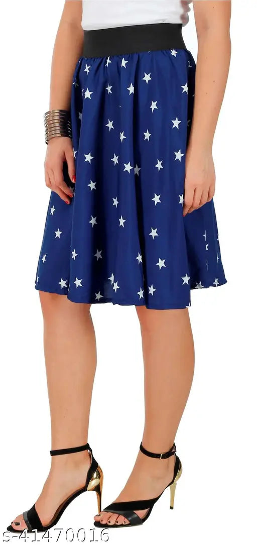 A woman standing, wearing a navy skirt with white stars and pattern, paired with black heels