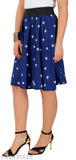 A woman standing, wearing a navy skirt with white stars and pattern, paired with black heels