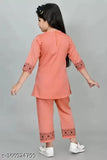 Green cotton kurtis and pyjama set for girls, printed design with three-quarter sleeves. Girls green cotton kurta & pajama sets on display