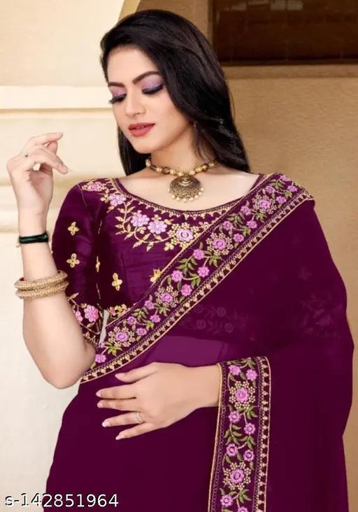 Purple saree with intricate embroidery, black borders and gold jewelry
